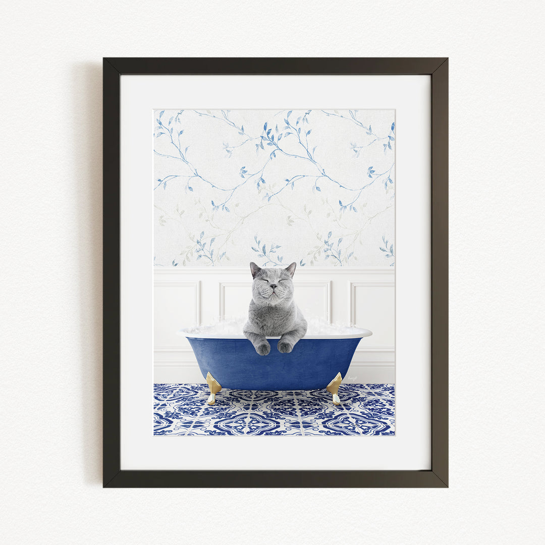 A gray cat sitting in a blue bathtub, with a patterned tile floor and a floral wallpaper in the background.