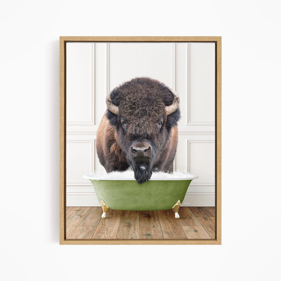 A buffalo with a black mane and horns is standing in a green bathtub, with its head poking out of the tub.