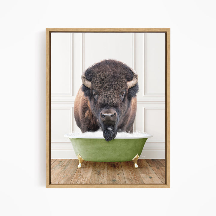 A buffalo with a black mane and horns is standing in a green bathtub, with its head poking out of the tub.