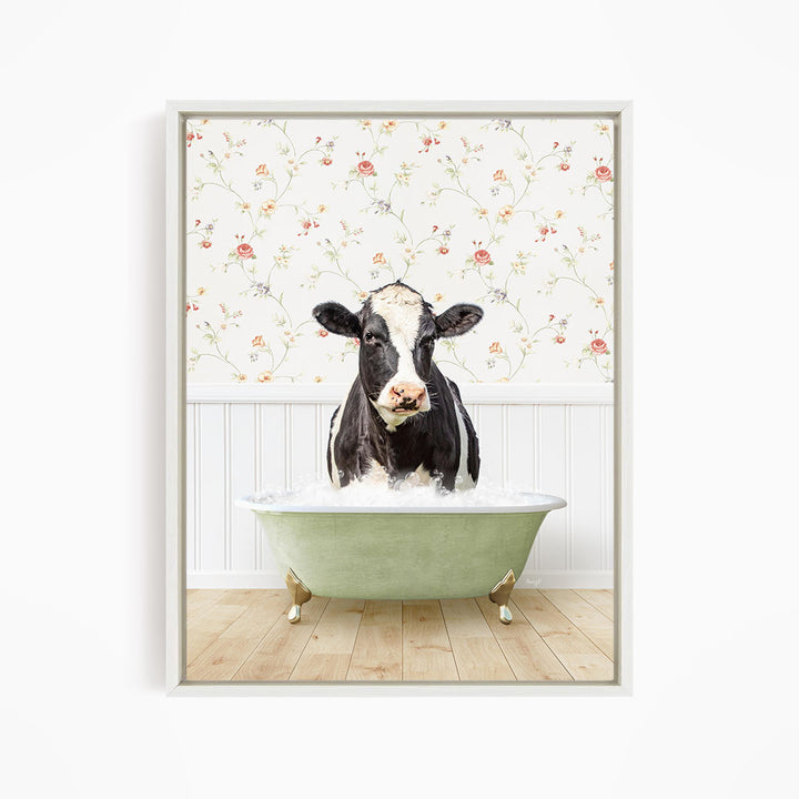 A black and white cow is sitting in a green bathtub filled with water, creating a whimsical and humorous scene.