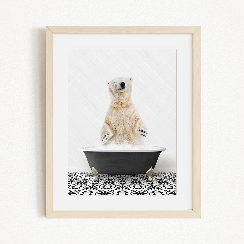 A polar bear standing in a black bathtub filled with water, with its paws raised in the air.