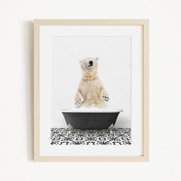 A polar bear standing in a black bathtub filled with water, with its paws raised in the air.