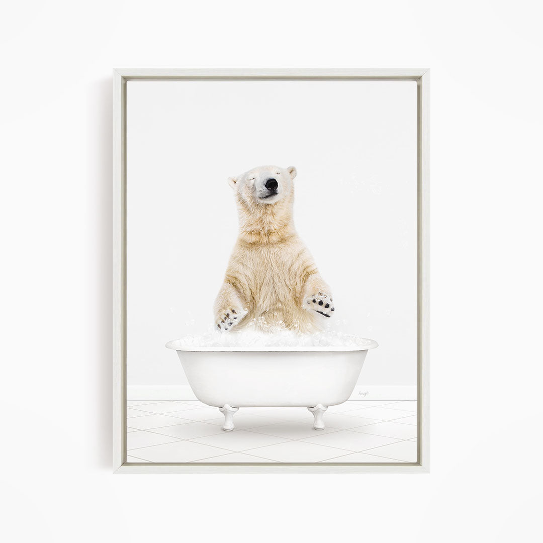 A polar bear standing in a white bathtub filled with water, appearing to be enjoying a bath.