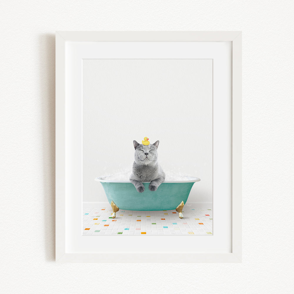 A gray cat sitting in a green bathtub, with two small gold birds perched on the sides of the tub.