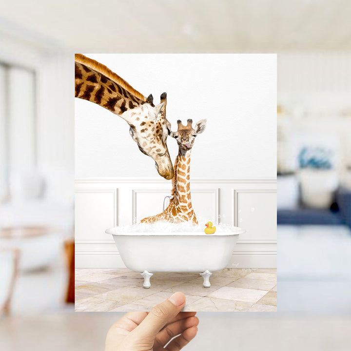 A mother giraffe and her baby giraffe are sitting together in a white bathtub, with a yellow rubber duck floating in the water.
