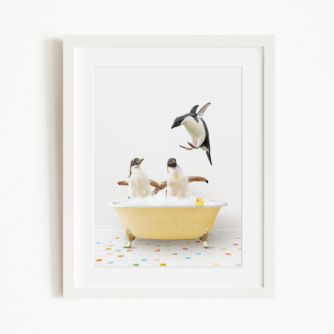 A framed image depicting two penguins sitting in a yellow bathtub, with one penguin flying towards the other.