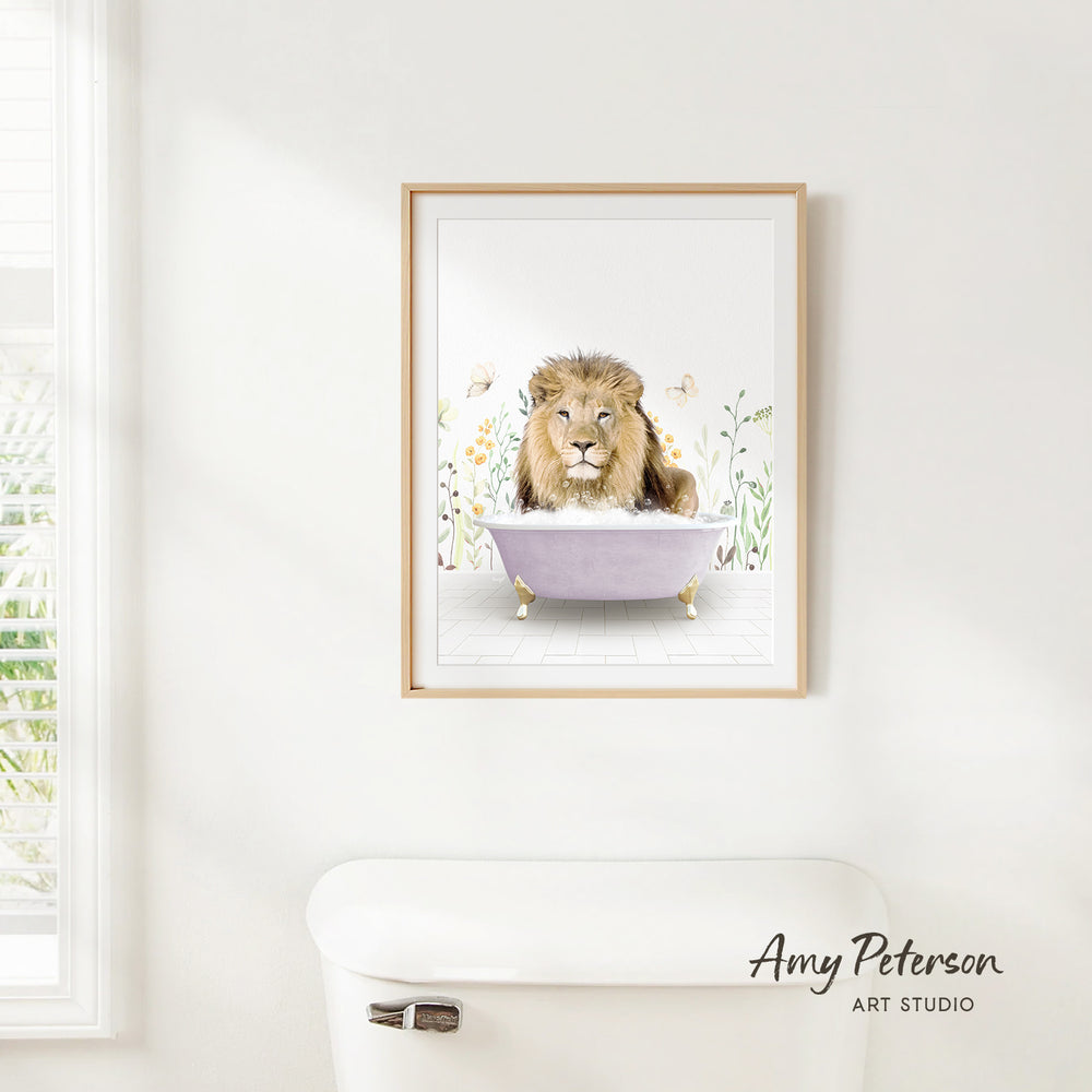 A framed illustration of a lion sitting in a bathtub, surrounded by flowers and plants, is hanging on a white wall.
