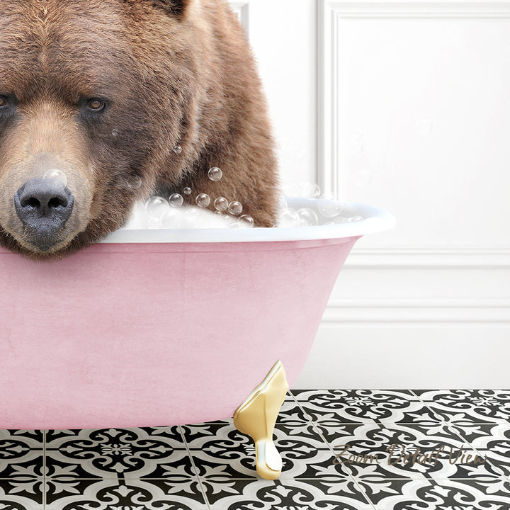 A brown bear is sitting in a pink bathtub filled with bubbles, creating a whimsical and playful scene.