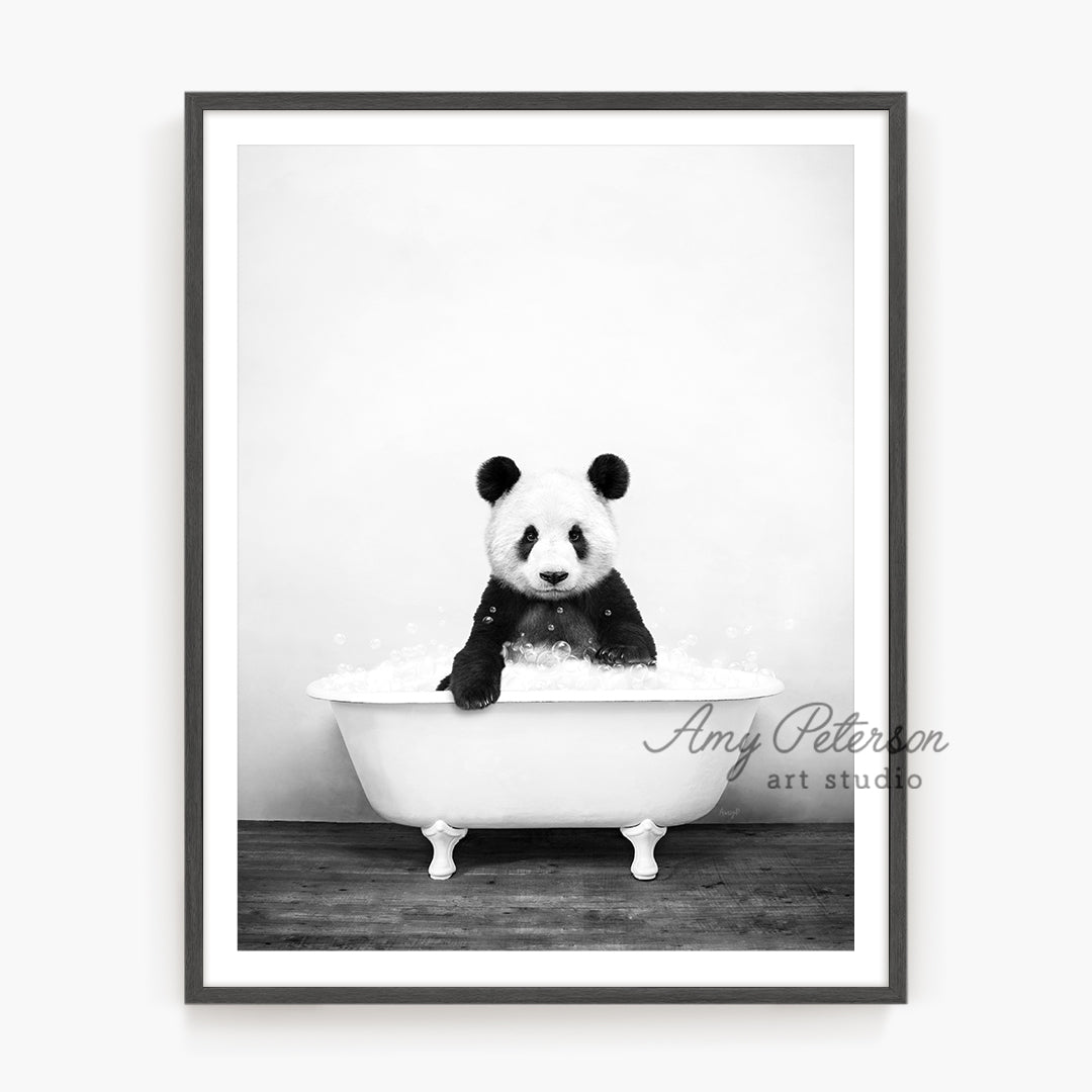 a black and white photo of a panda in a bathtub