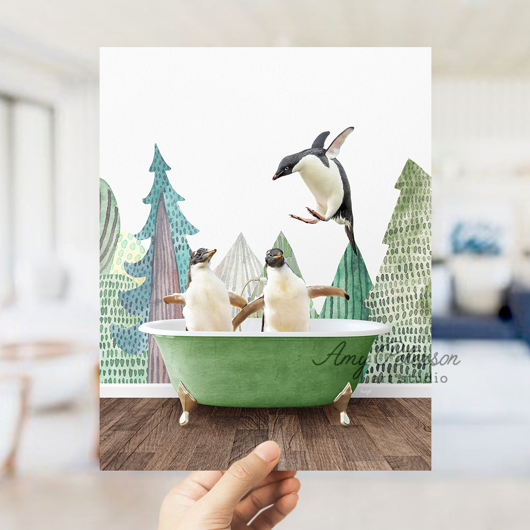 a hand holding up a card with penguins in a bathtub