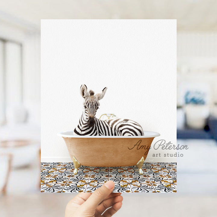 a hand holding a card with a zebra in a bathtub