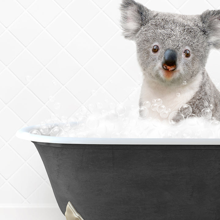 a koala is sitting in a bathtub with bubbles