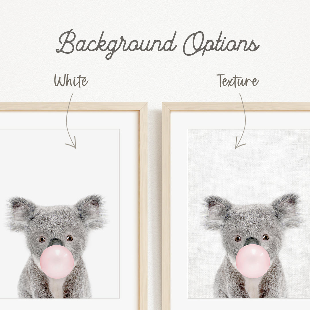 a gray koala bear blowing a bubble with a pink bubble gum bubble.