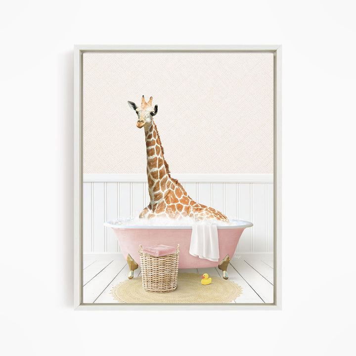 A giraffe sitting in a pink bathtub, surrounded by a yellow rubber duck and a basket.