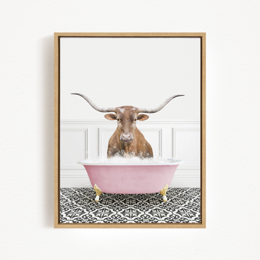 A brown bull with long horns is sitting in a pink bathtub filled with bubbles, creating a whimsical and playful scene.