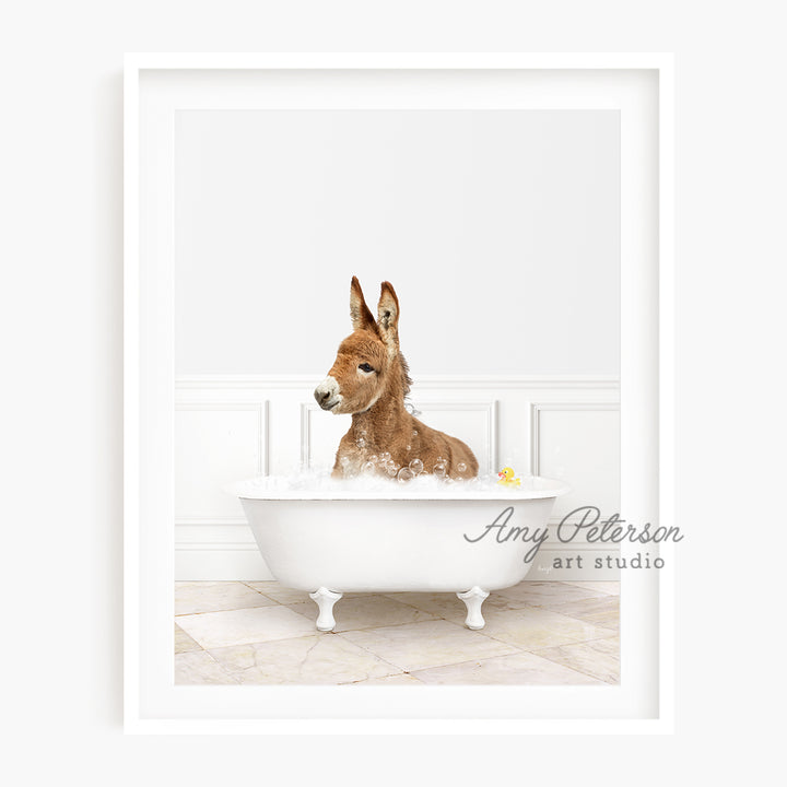 a dog sitting in a bathtub with a rubber duck in it's mouth