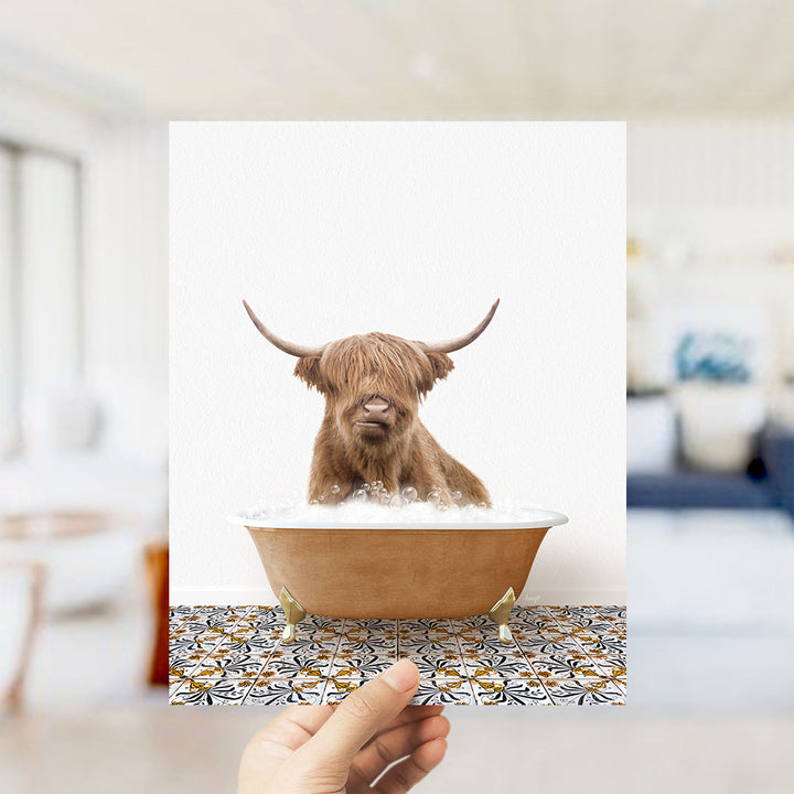 A Highland cow with long horns is sitting in a bathtub filled with water, creating a whimsical and amusing scene.