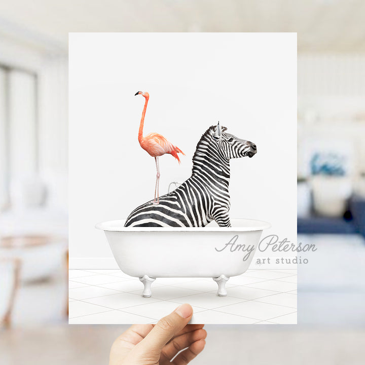 a hand holding a card with a zebra and a flamingo in a bathtub