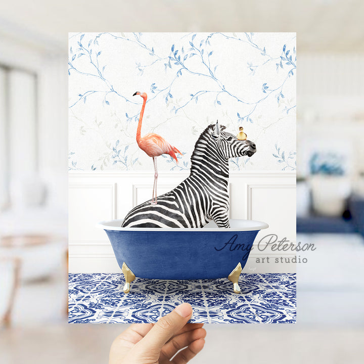 a hand holding a card with a zebra and a flamingo in a bathtub