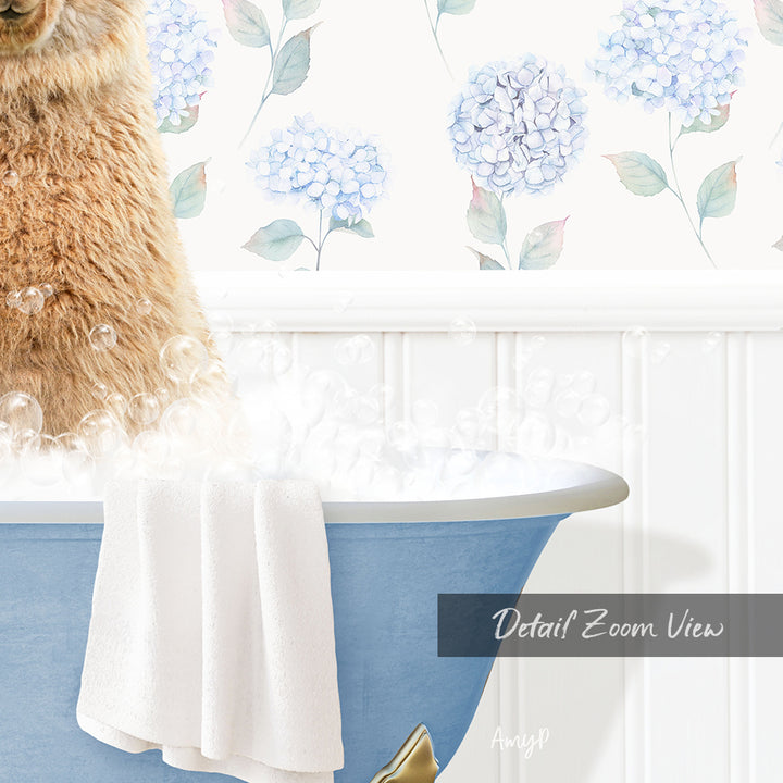 A fluffy brown dog is sitting in a blue bathtub filled with bubbles, with a towel hanging on the side and a floral wallpaper in the background.