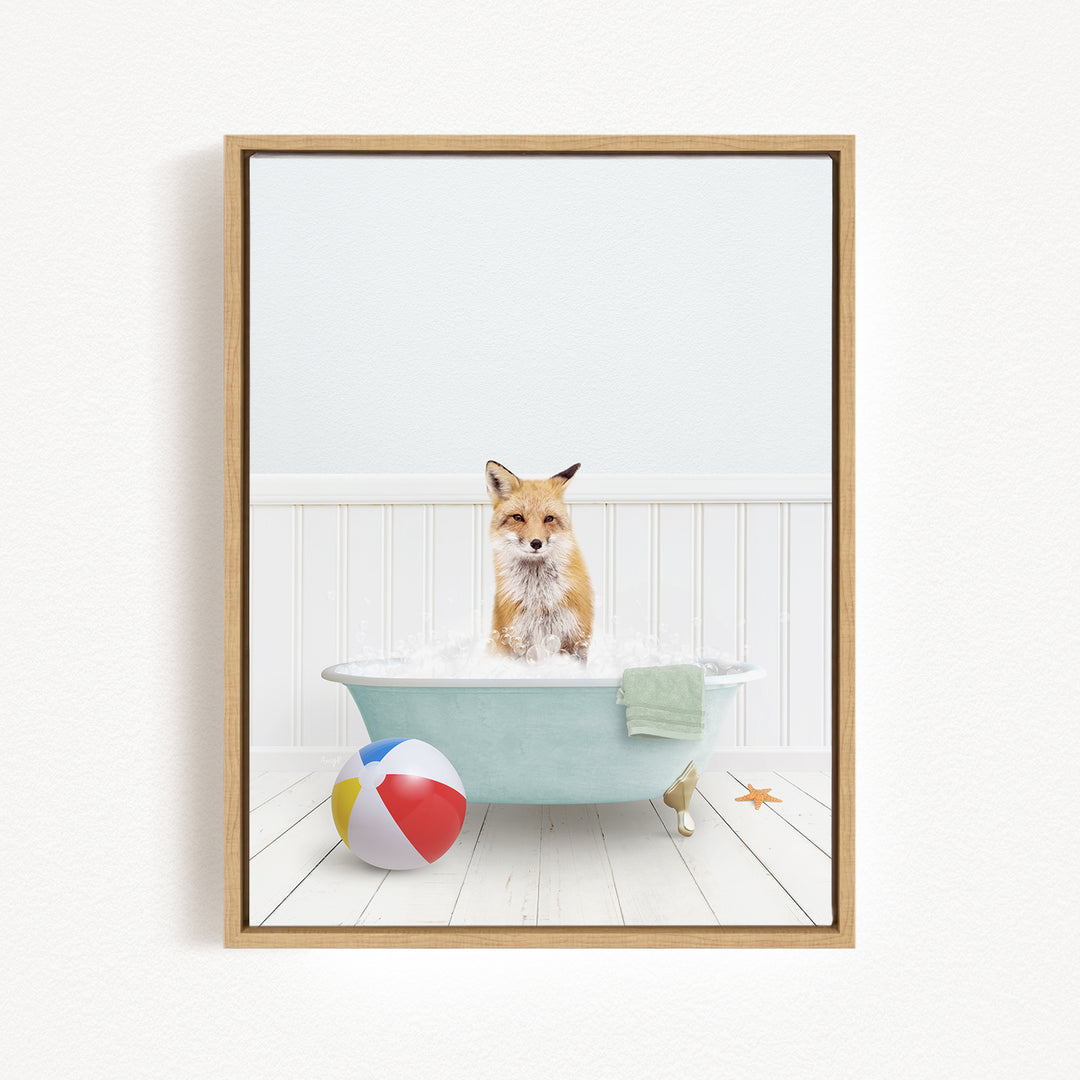 A fox is sitting in a bathtub filled with bubbles, surrounded by a beach ball and a towel.