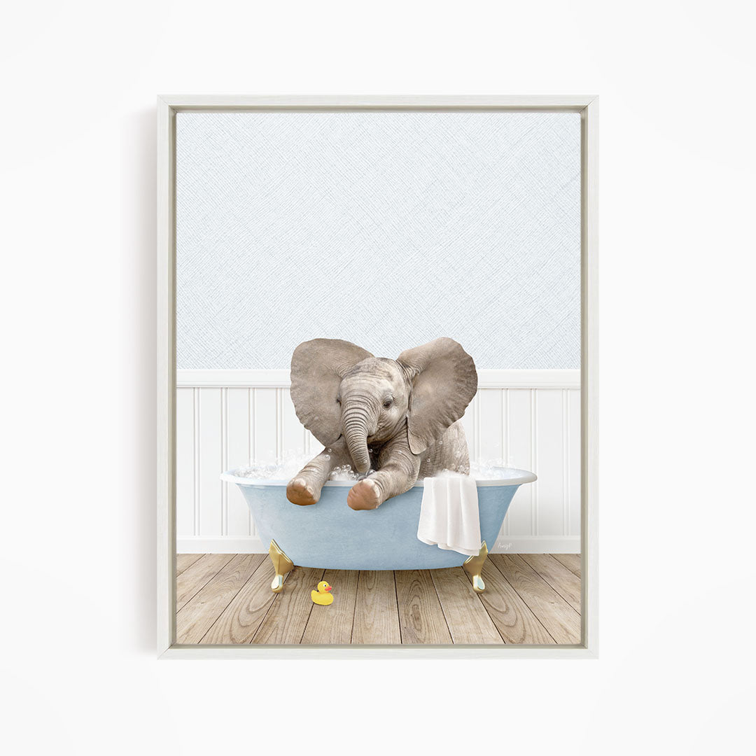 A baby elephant sitting in a blue bathtub, surrounded by rubber duckies, in a white-framed picture.