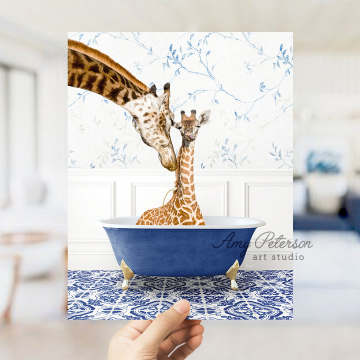 a hand holding a card with a picture of two giraffes in a