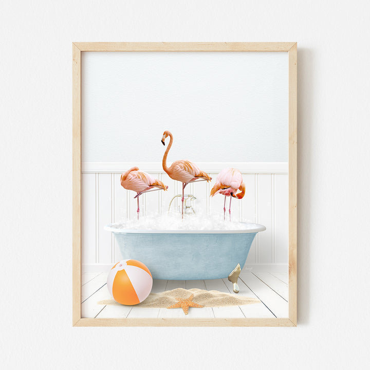 three flamingos in a bathtub with a beach ball