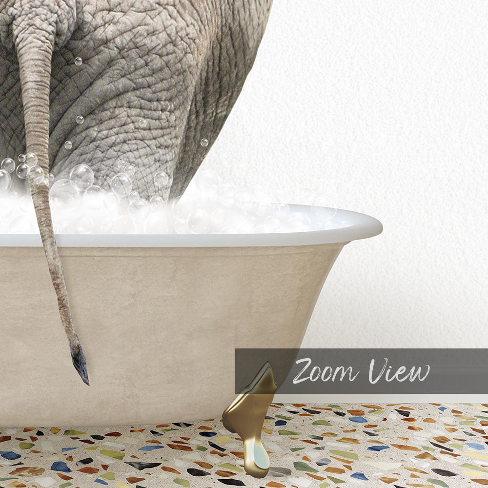 An elephant is standing in a bathtub filled with bubbles, with its tail hanging over the edge.