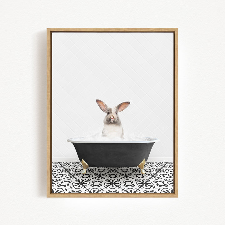A white rabbit sitting in a black bathtub filled with water, with a black and white patterned tile floor beneath it.