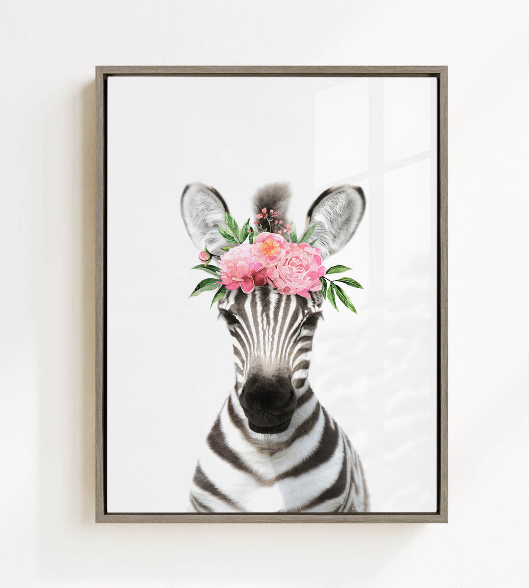 A zebra wearing a floral headpiece with pink flowers and green leaves.