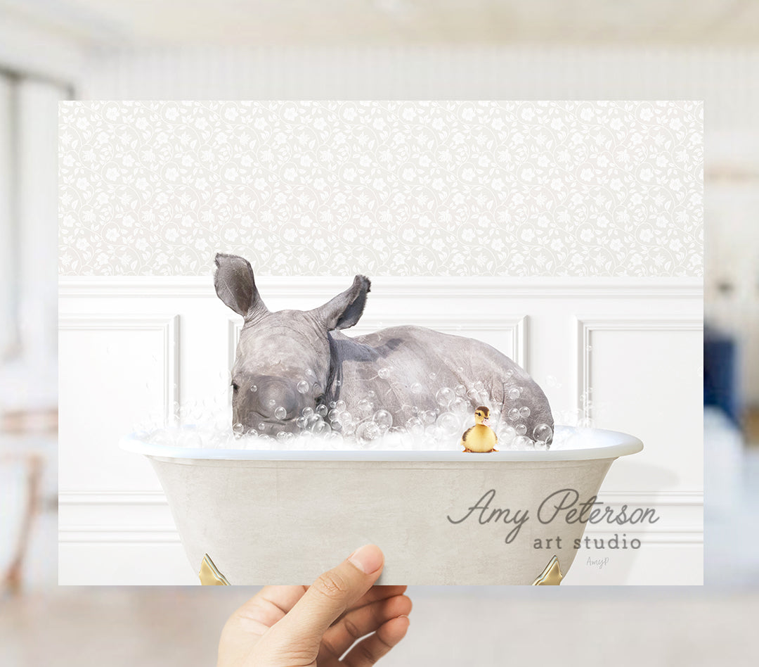 a person holding a picture of a rhino in a bathtub