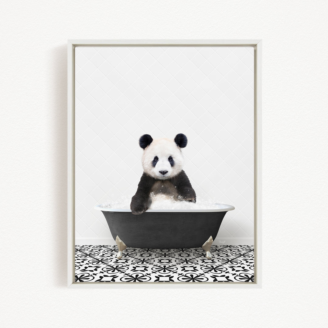 A panda bear sitting in a bathtub filled with bubbles, surrounded by a black and white patterned floor.