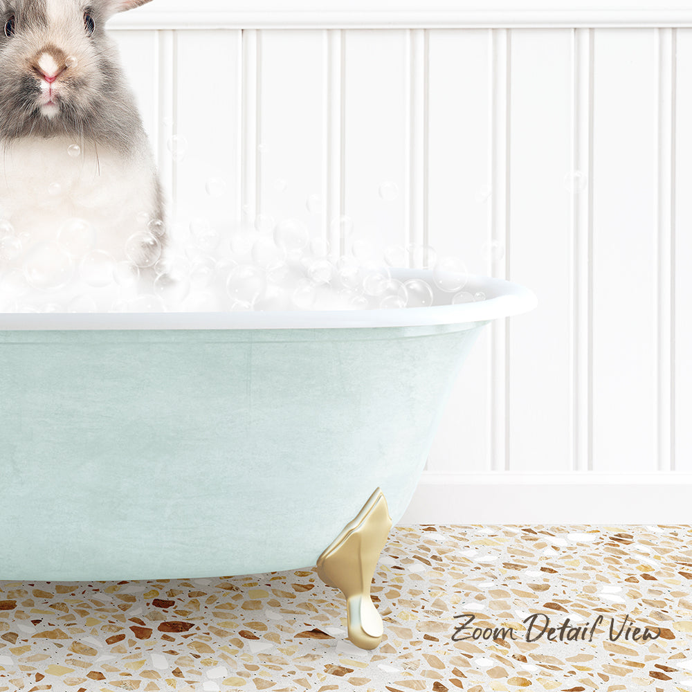 A small rabbit sitting in a light blue bathtub filled with bubbles, with a white tiled wall in the background.