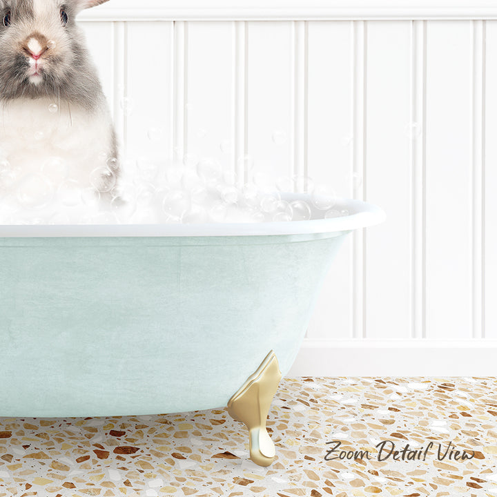 A small rabbit sitting in a light blue bathtub filled with bubbles, with a white tiled wall in the background.