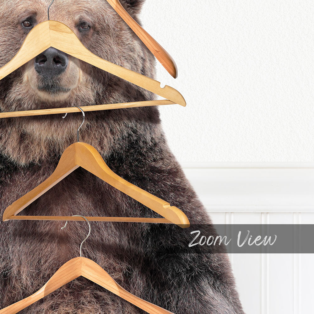 A close-up of a large brown bear with multiple wooden hangers attached to its head and neck, creating a unique and whimsical scene.