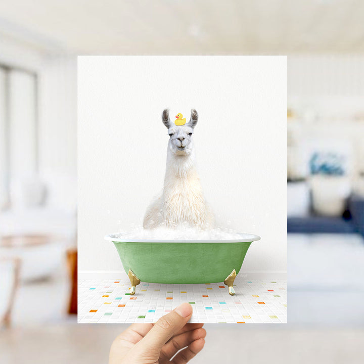 A white llama sitting in a green bathtub filled with bubbles, wearing a yellow rubber duck on its head.