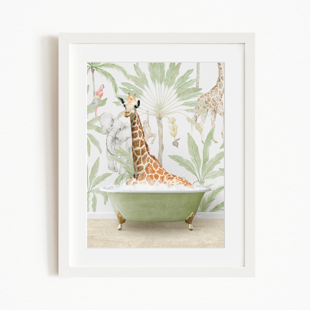 A giraffe is sitting in a green bathtub, surrounded by tropical foliage, in a framed artwork.