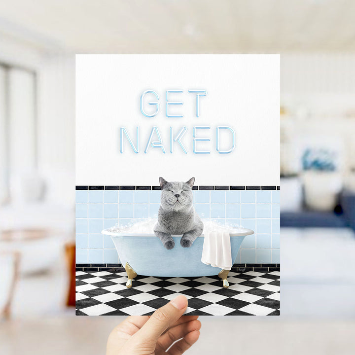 A hand holding a card with a cat sitting in a bathtub filled with bubbles, with the text "GET NAKED" displayed prominently.