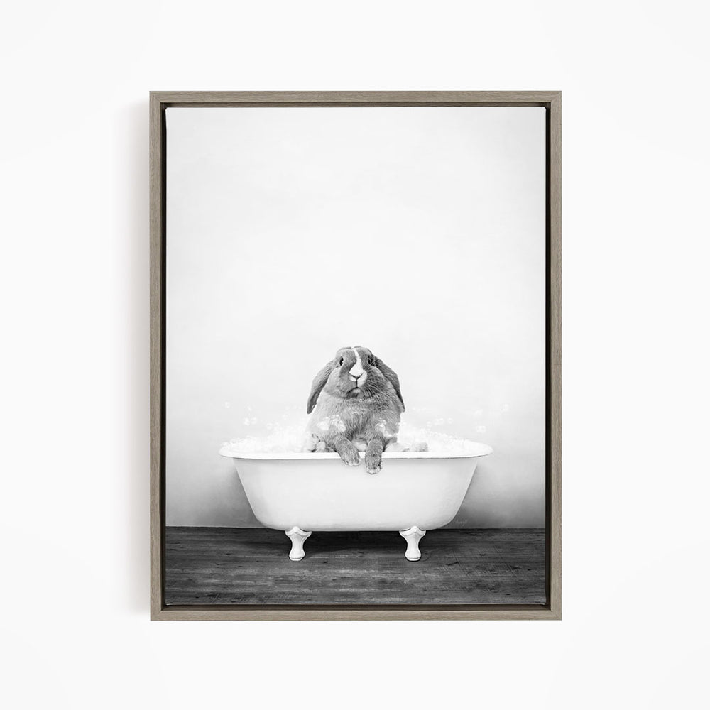 A rabbit sitting in a bathtub filled with water, enjoying a bath.