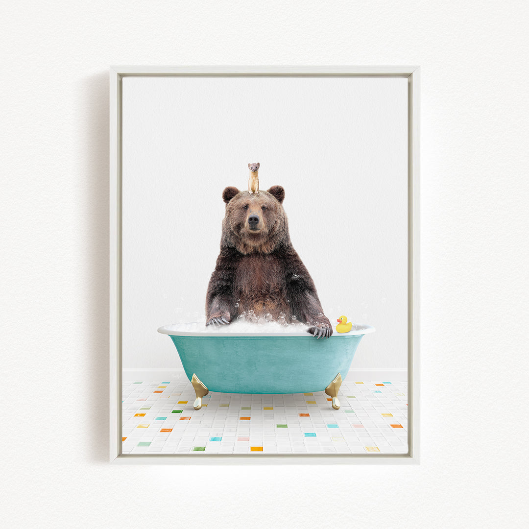 A brown bear sitting in a blue bathtub, surrounded by colorful tiles on the floor.