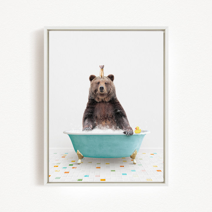 A brown bear sitting in a blue bathtub, surrounded by colorful tiles on the floor.