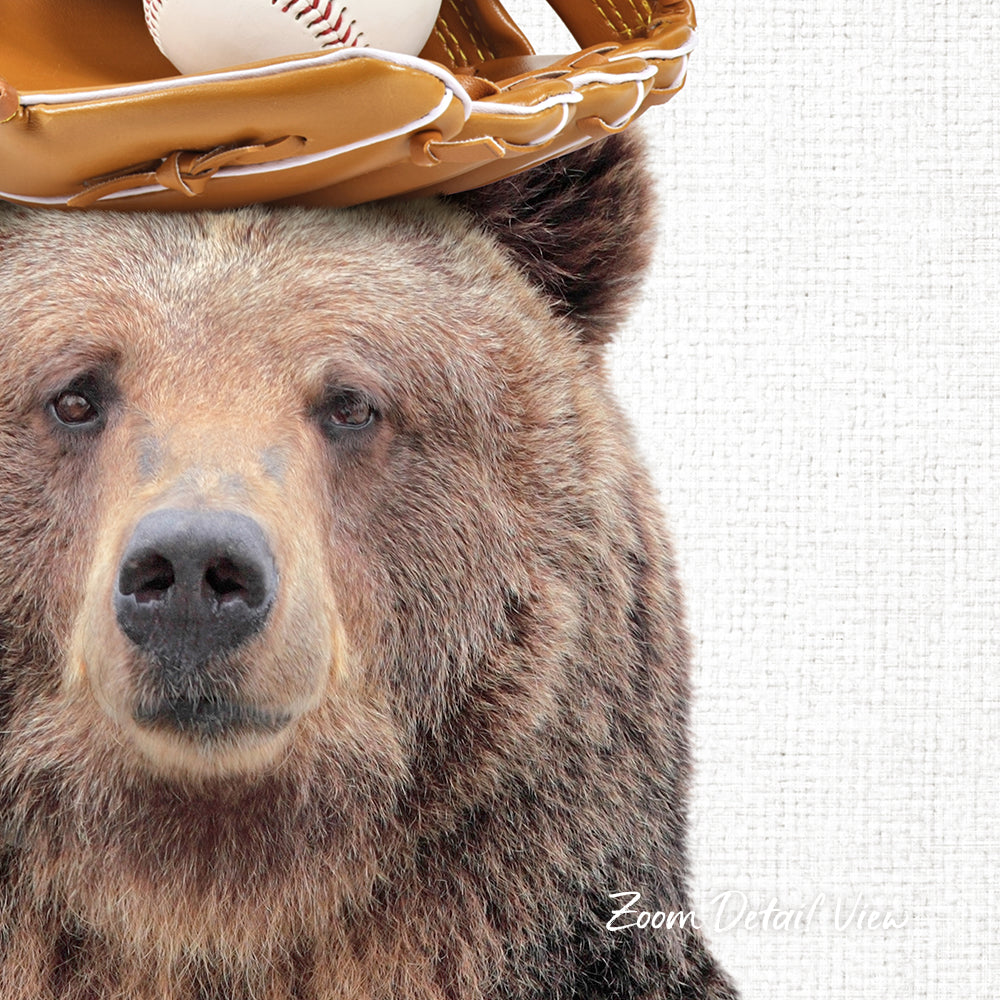 A close-up of a brown bear wearing a baseball glove on its head, with a baseball visible in the glove.