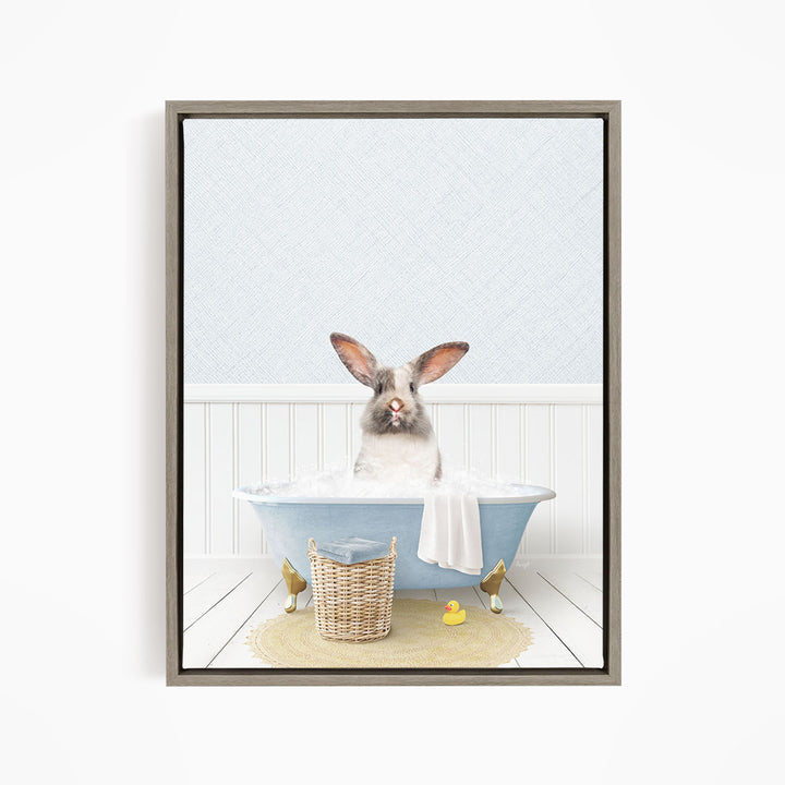 A rabbit sitting in a blue bathtub filled with water, surrounded by a yellow rubber duck and a basket.