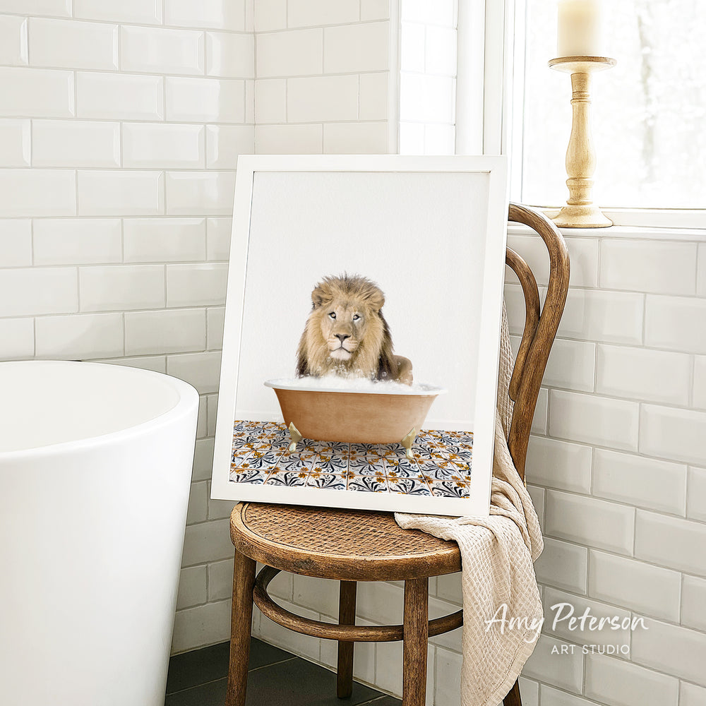 A framed image of a lion sitting in a bathtub, surrounded by a patterned design, is displayed on a wooden chair in a bathroom setting.