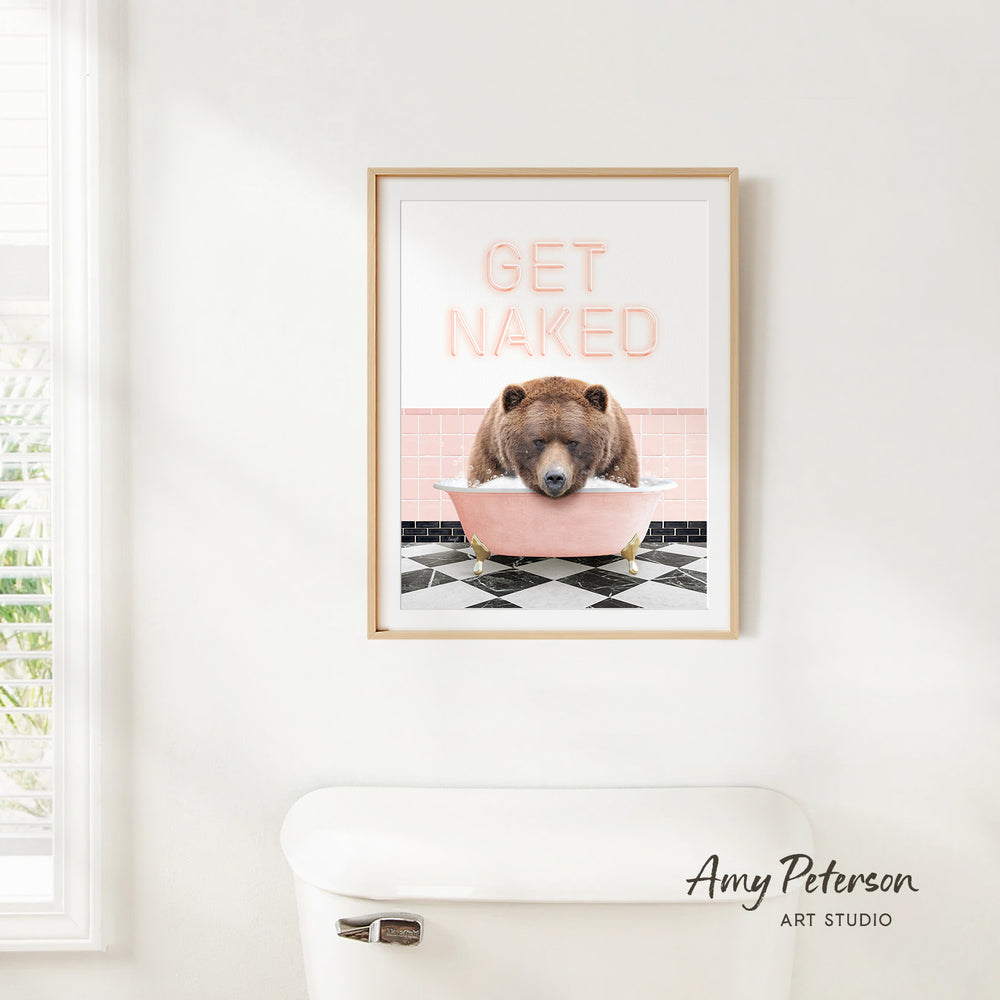 A framed print with a bear sitting in a pink bathtub, with the text "GET NAKED" displayed above it.