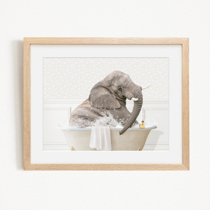 A gray elephant is sitting in a bathtub filled with water, surrounded by bubbles, with a yellow rubber duck floating nearby.