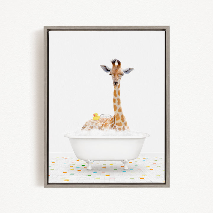 A giraffe is sitting in a white bathtub filled with bubbles, surrounded by a yellow rubber duck.
