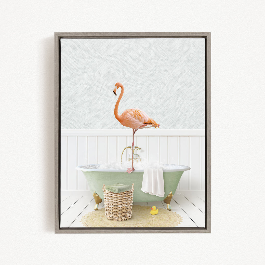 A pink flamingo stands on the edge of a green bathtub, with a basket and rubber duckies nearby, in a bathroom setting.