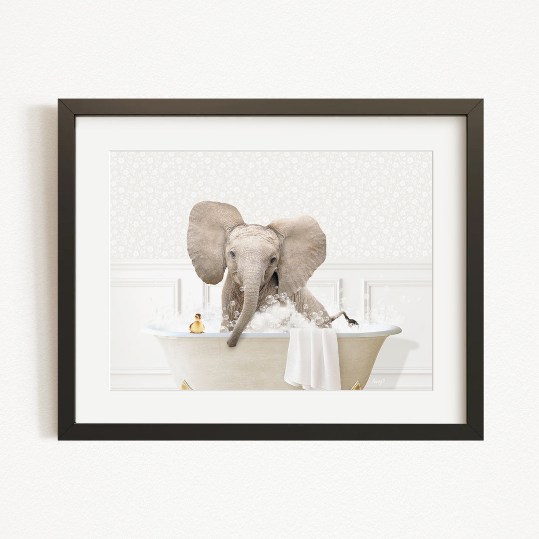A baby elephant sitting in a bathtub filled with water, surrounded by bubbles and toys.